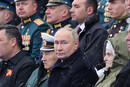 Зрители, включая Путина, смотрят военный парад на Красной площади в Москве, 9 мая 2024 года
